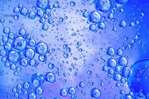 Abstract blue colorful background with oil on water surface. Oil drops in water abstract psychedelic, abstract image. photo