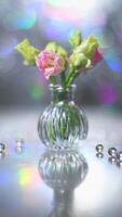 Beautiful pink and green flowers in a vase on a table photo