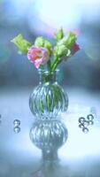 Beautiful pink and green flowers in a vase on a table photo