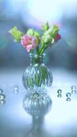 Beautiful pink and green flowers in a vase on a table photo