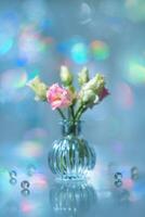 Beautiful pink and green flowers in a vase on a table photo