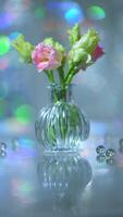 Beautiful pink and green flowers in a vase on a table photo