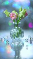Beautiful pink and green flowers in a vase on a table photo