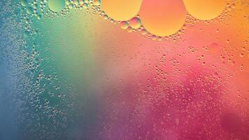 Abstract yellow, green and pink colorful background with oil on water surface. Oil drops in water abstract psychedelic, abstract image. photo