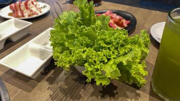 there is a salad and a drink on the table photo