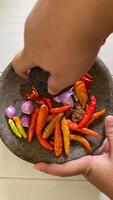 there is a bowl of peppers and other vegetables on a table photo