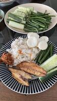 there are two plates of food on a table with a bowl of rice photo