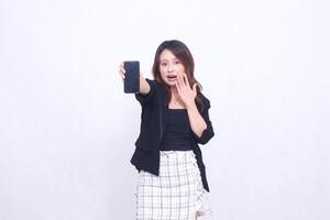 Beautiful Indonesian office woman in her 20s, expression of surprise, promotion on cellphone gadget screen in the future for promo, isolated on white background photo