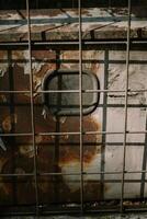 A network server in a public space, securely enclosed in a metal cage, highlighting technology and security measures photo