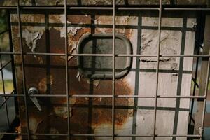 A network server in a public space, securely enclosed in a metal cage, highlighting technology and security measures photo