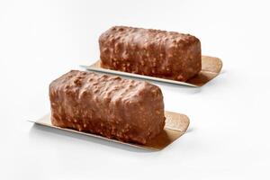 Two nuts and chocolate covered ice cream bars on white photo
