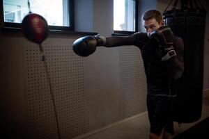 Fighter sharpening accuracy using double-end bag in boxing gym photo