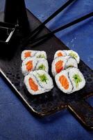 Yin and yang shaped futomaki rolls with salmon and cucumber photo