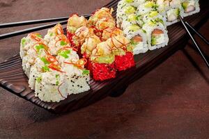 Enticing set of sushi rolls on wooden serving tray photo