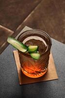 Refreshingly herbal and floral gin garden with cucumber slice photo