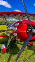 Old red airplane turboprop engine with propeller blades, parts of wings and aircraft fuselage photo