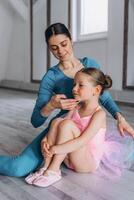 Baby ballet studio. Little ballerina with a coach in dance class. Ballet trainer for children photo