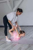 Baby ballet studio. Little ballerina with a coach in dance class. Ballet trainer for children photo