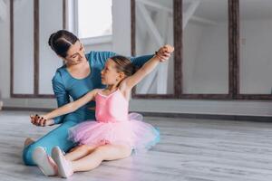Baby ballet studio. Little ballerina with a coach in dance class. Ballet trainer for children photo