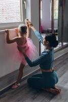 Baby ballet studio. Little ballerina with a coach in dance class. Ballet trainer for children photo