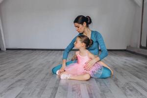 Baby ballet studio. Little ballerina with a coach in dance class. Ballet trainer for children photo