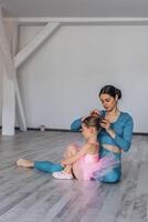 Baby ballet studio. Little ballerina with a coach in dance class. Ballet trainer for children photo