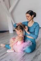 Baby ballet studio. Little ballerina with a coach in dance class. Ballet trainer for children photo