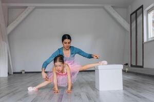 Baby ballet studio. Little ballerina with a coach in dance class. Ballet trainer for children photo