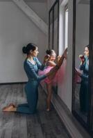 Baby ballet studio. Little ballerina with a coach in dance class. Ballet trainer for children photo