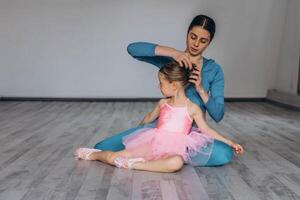 Baby ballet studio. Little ballerina with a coach in dance class. Ballet trainer for children photo
