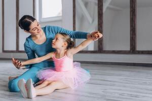 Baby ballet studio. Little ballerina with a coach in dance class. Ballet trainer for children photo