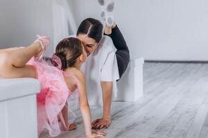 Baby ballet studio. Little ballerina with a coach in dance class. Ballet trainer for children photo
