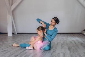 Baby ballet studio. Little ballerina with a coach in dance class. Ballet trainer for children photo