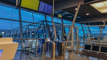 An empty terminal, aircrafts are waiting and preparing for their next flight and one of them taken off photo