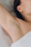 Sugaring. epilation with liquate sugar at armpit. photo
