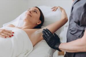 Sugaring. epilation with liquate sugar at armpit. photo