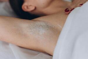 Sugaring. epilation with liquate sugar at armpit. photo