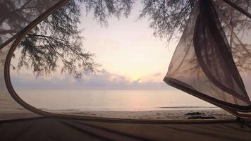 Zoom in open tent view from inside panoramic view to spectacular sunrise on the beach. First Person point of view rise early watch sunrise concept.Copy space relaxing camping video