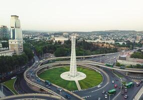 Tbilisi, Georgia - 15th july, 2022 - static view automobiles in traffic on roundabout in Tbilisi center. Square of heroes monument photo