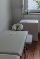 Massage table close-up. Massage table with headrest and hand rests. photo