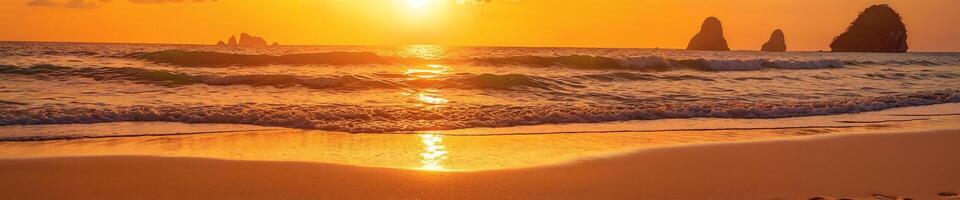 A beautiful beach scene with a sunset over the ocean. The sun is setting, casting a warm glow on the water and sand. The waves are gently rolling onto the shore, creating a serene atmosphere. photo