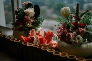 Exquisite floral centerpiece adorning a hotel table, adding a touch of elegance and freshness to the ambiance. photo