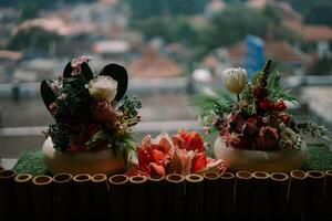 Exquisite floral centerpiece adorning a hotel table, adding a touch of elegance and freshness to the ambiance. photo