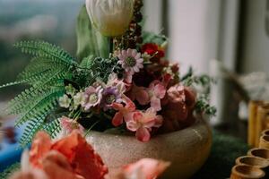Exquisite floral centerpiece adorning a hotel table, adding a touch of elegance and freshness to the ambiance photo