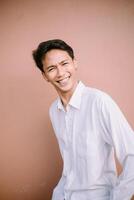 A man with a wide smile, looking forward, radiating joy and friendliness. photo