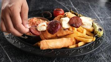 Delicious Mixed Grill Platter with fries, veggies, beautifully presented on a decorative plate video