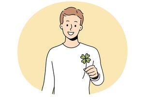 Smiling man holding clover with four leaves vector