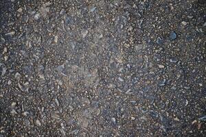 Concrete road have a rough surface. Gravel craggy texture and background photo