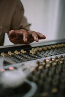 An audio mixer with its knobs and sliders meticulously adjusted, embodying precision and control in the art of sound engineering and music production photo