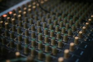 An audio mixer with its knobs and sliders meticulously adjusted, embodying precision and control in the art of sound engineering and music production photo
